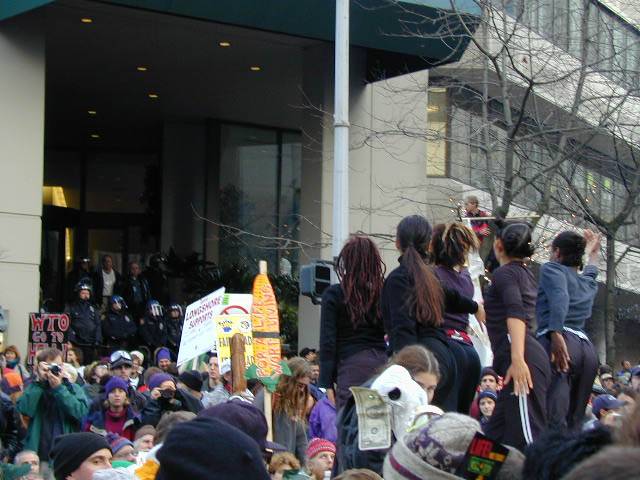 Art and rev dancing in middle of intersection with sitting protestors.jpg