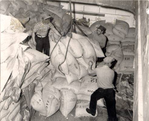 Sacks of coffee being lifted from the hold of the Coastal Conqueror April 20 1946 AAC-2159.jpg