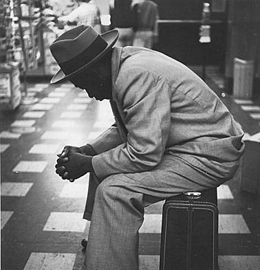 Black-man-on-suitcase-left-profile.jpg