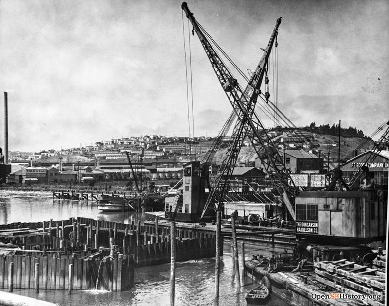 View Northwest from Islais Creek Bridge, 3rd Street. Duncanson-Harrelson Co. cranes, F. E. Booth Company (sardine cannery), Cargill warehouses. Potrero Hill with public housing in distance 1950s wnp37.03830.jpg