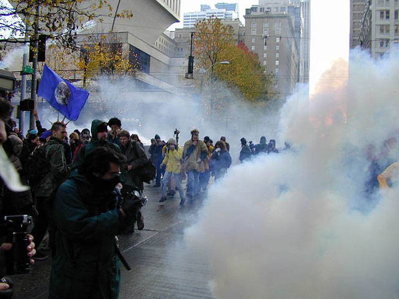 Teargas-on-street-with-earth-flag.jpg