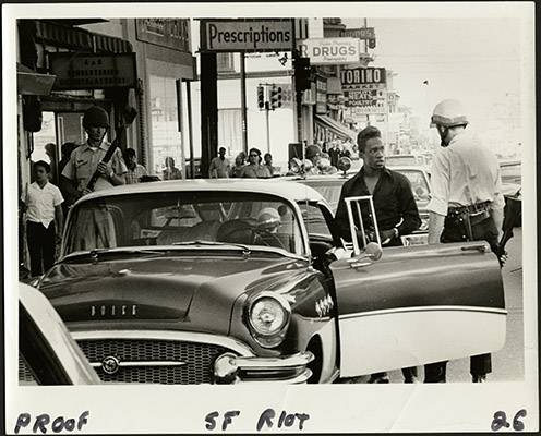 File:Police officer talking to a man during the 1966 Bayview-Hunters Point riots on Third Street at Palou Avenue AAK-1658.jpg