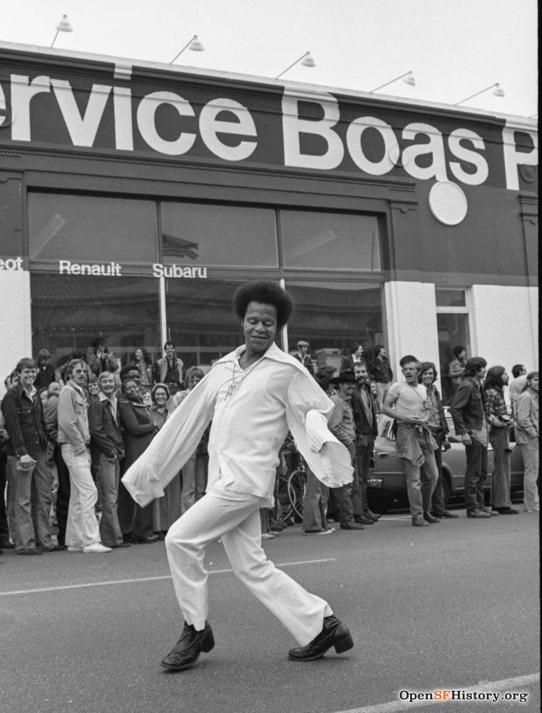 1974 Gay Freedom Day Man dancing in Gay Freedom Day parade- Crowd smiling and laughing wnp72.086.jpg