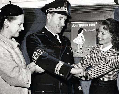 Mrs. Haurat, area chairman, and Mrs. Valdespino, chairman of the Mother's March on Polio with Deputy Police Chief Thomas Cahill jan 28 1957 AAK-1326.jpg