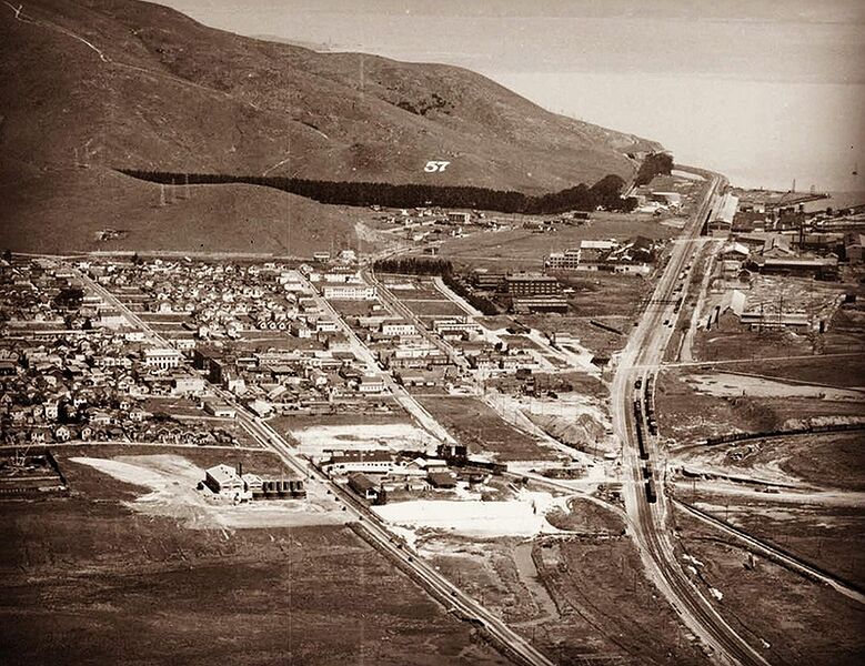 File:Aerial view from 1929. Peck’s Lots and 57 Hill. Southern Pacific Bayshore Cutoff is lined with heavy industry. At the middle left is Southern Pacific’s South San Francisco station.jpg